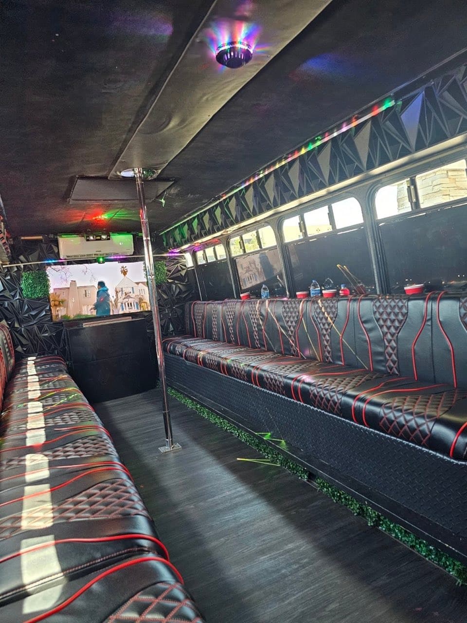 TVs and seating inside the LYTT party bus
